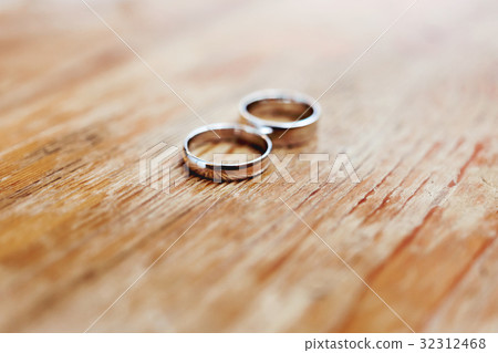 golden wedding rings on shabby wooden background golden wedding rings on shabby wooden background 32312468