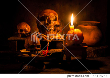 Skull and candle with candlelight on wooden Skull and candle with candlelight on wooden 32314735