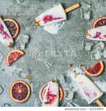 Orange, yogurt, granola popsicles on ice cubes Orange, yogurt, granola popsicles on ice cubes 32314903