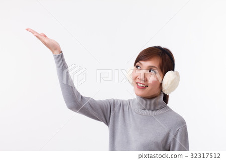 fall or winter asian woman pointing and looking up 32317512