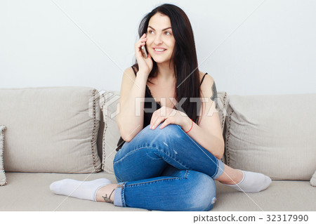 Woman reading on her mobile phone and smiling 32317990