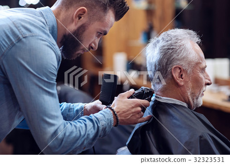 Professional experienced barber working with hair 32323531