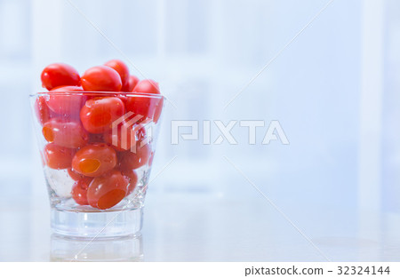 small red cherry tomatoes in clear glass cup small red cherry tomatoes in clear glass cup 32324144