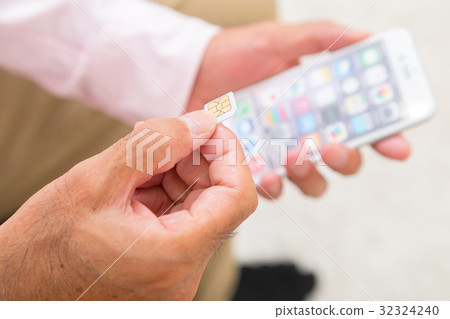 Senior generation male with sim card Senior portrait 50's 60's Senior generation male with sim card Senior portrait 50's 60's 32324240