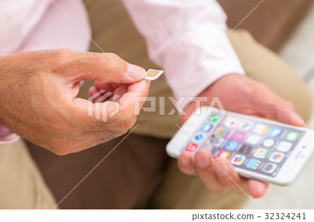 Senior generation male with sim card Senior portrait 50's 60's 32324241