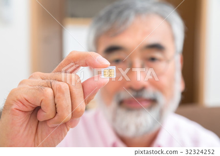 Senior generation male with sim card Senior portrait 50's 60's 32324252