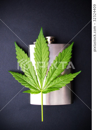 Marijuana leaf on a hip flask Marijuana leaf on a hip flask 32324409