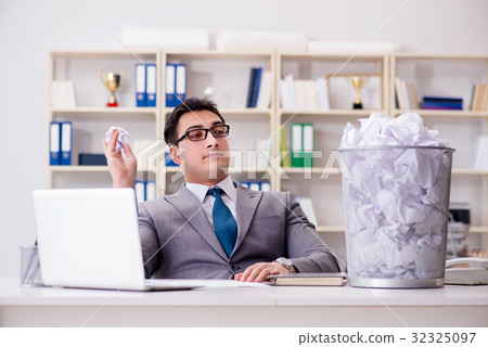 Businessman in paper recycling concept in office Businessman in paper recycling concept in office 32325097