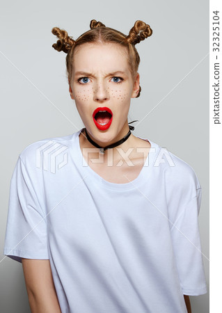 Funny girl with painted freckles looking surprised 32325104