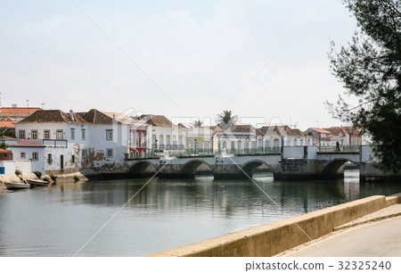 medieval bridge over Gilao River in Tavira city medieval bridge over Gilao River in Tavira city 32325240