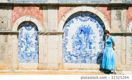 tourist near outside wall of Estoi Palace 32325264