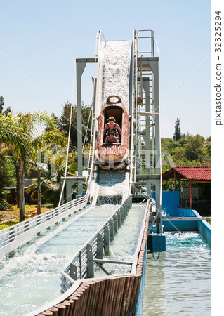visitors in boat on water slide attraction 32325294