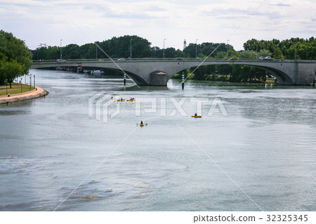 Rhone river with bridge and canoes in Avignon city 32325345
