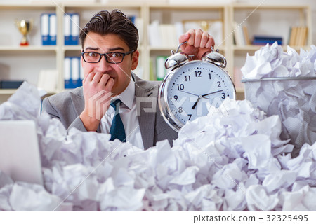 Businessman in paper recycling concept in office 32325495