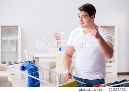 Man doing laundry at home 32325962