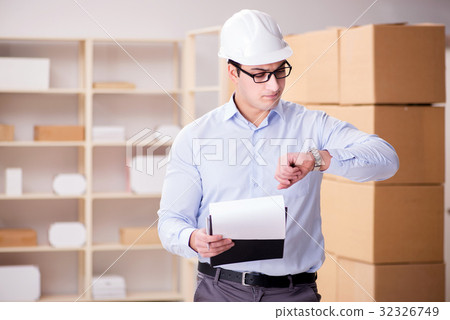 Young worker in the postal office dealing with Young worker in the postal office dealing with 32326749
