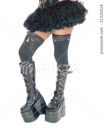 Legs of woman in long black boots. 32326828