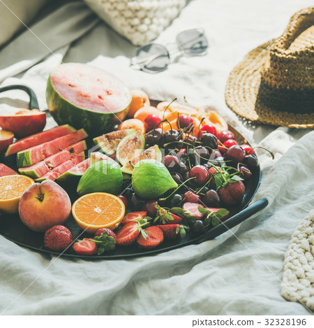 Tray full of fruit over light blanket background Tray full of fruit over light blanket background 32328196