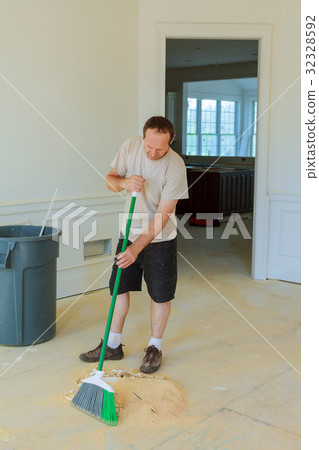 Handyman cleaning with squeegees in a new house Handyman cleaning with squeegees in a new house 32328592
