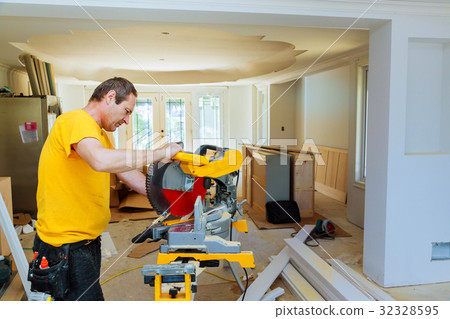 Contractor Using Circular Saw Cutting Moulding  32328595