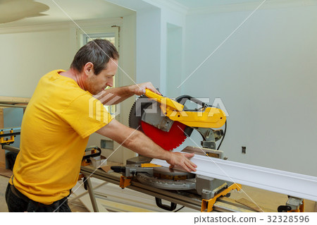 Contractor Using Circular Saw Cutting Moulding Contractor Using Circular Saw Cutting Moulding 32328596