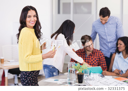 Side view of businesswoman with colleagues Side view of businesswoman with colleagues 32331375