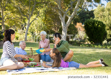 Happy family having picnic in the park Happy family having picnic in the park 32331441