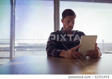 Businessman using digital table at office 32331454
