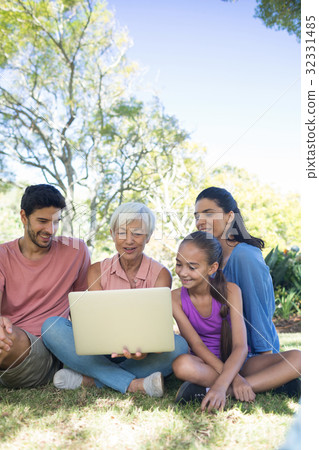Family using laptop in the park 32331485