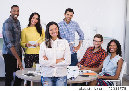 Portrait of smiling business colleagues at desk 32331776