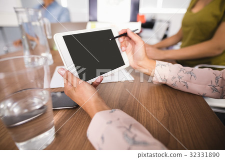 Hands of businesswoman using digital tablet at creative office Hands of businesswoman using digital tablet at creative office 32331890