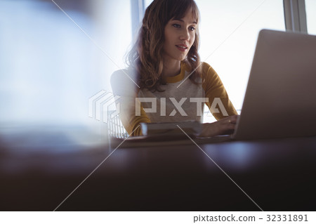 Concentrated businesswoman working at office 32331891
