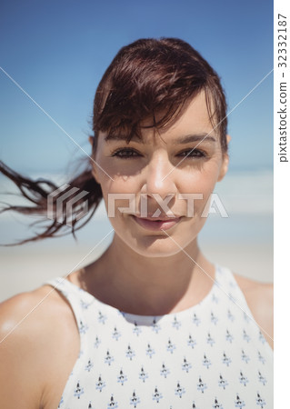 Portrait Of Young Woman With Tousled Hair At Beach Stock Photo
