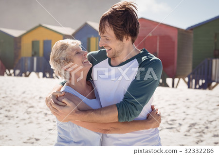 Happy mother embracing her son at beach Happy mother embracing her son at beach 32332286