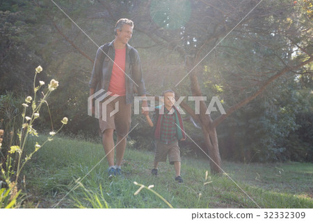 Happy father and son hiking on grass Happy father and son hiking on grass 32332309