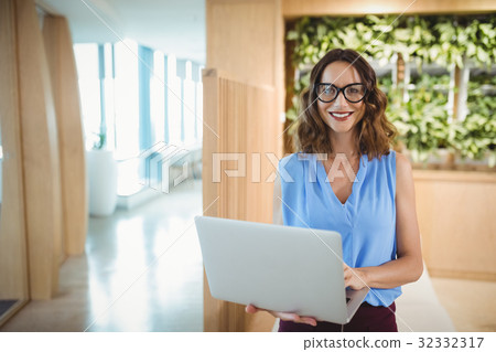 Portrait of smiling executive using laptop 32332317
