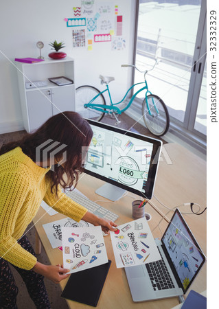 Female graphic designer working at office desk 32332329