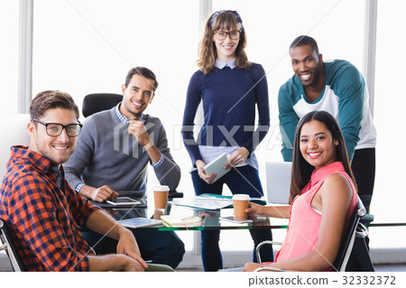 Portrait of confident business people at desk 32332372