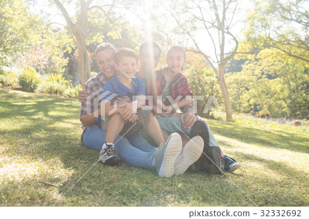 Happy family sitting in the park 32332692