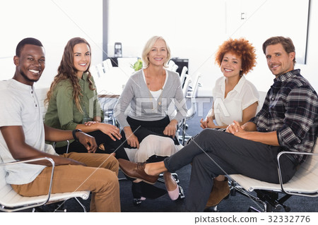 Portrait of smiling business people sitting on chairs 32332776