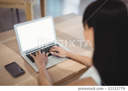 Attentive executive using laptop at desk 32332779