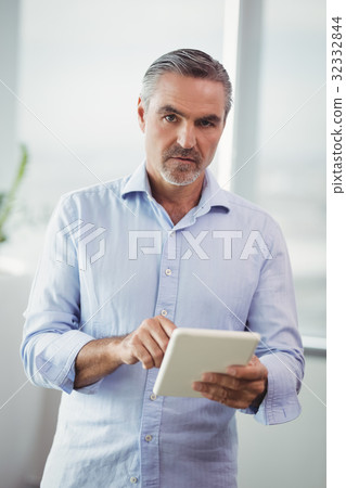 Portrait of executive using digital tablet Portrait of executive using digital tablet 32332844