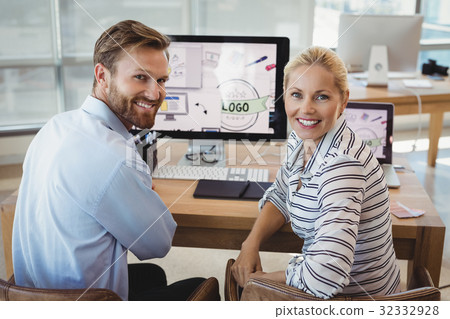 Portrait of executives sitting at desk 32332928