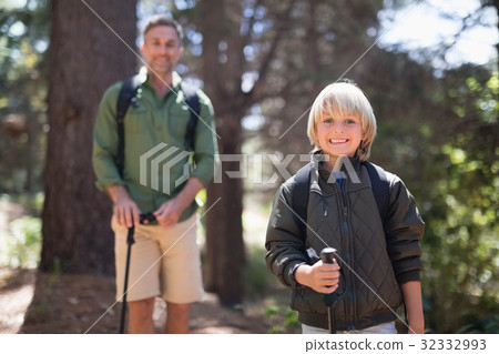 Portrait of son and father hiking on sunny day 32332993