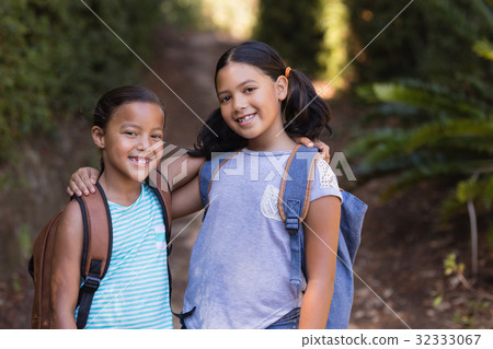 Smiling friends standing at natural parkland Smiling friends standing at natural parkland 32333067