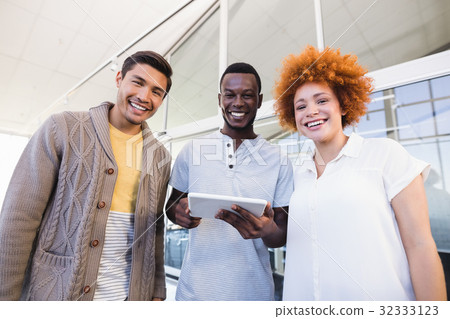 Portrait of cheerful business people with digital tablet 32333123