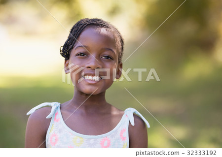 Smiling girl standing in forest 32333192