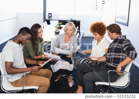 Business people discussing while sitting on chairs 32333232