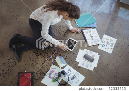 Graphic designer with digital table working on floor Graphic designer with digital table working on floor 32333313