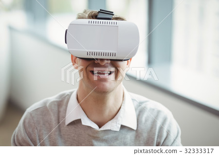 Happy executive using virtual reality headset Happy executive using virtual reality headset 32333317